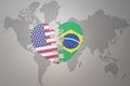 Puzzle heart with the national flag of united states of america and brazil on a world map background. Concept Royalty Free Stock Photo