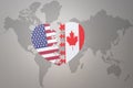 Puzzle heart with the national flag of united states of america and canada on a world map background. Concept Royalty Free Stock Photo