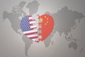 Puzzle heart with the national flag of united states of america and china on a world map background. Concept Royalty Free Stock Photo