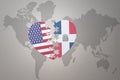 Puzzle heart with the national flag of united states of america and dominican republic on a world map background. Concept Royalty Free Stock Photo