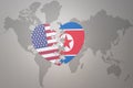 Puzzle heart with the national flag of united states of america and north korea on a world map background. Concept Royalty Free Stock Photo