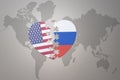 Puzzle heart with the national flag of united states of america and russia on a world map background. Concept Royalty Free Stock Photo