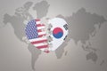 Puzzle heart with the national flag of united states of america and south korea on a world map background. Concept Royalty Free Stock Photo