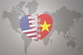 Puzzle heart with the national flag of united states of america and vietnam on a world map background. Concept Royalty Free Stock Photo