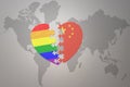 Puzzle heart with the rainbow gay flag and china on a world map background. Concept Royalty Free Stock Photo