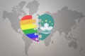 Puzzle heart with the rainbow gay flag and Macau on a world map background. Concept Royalty Free Stock Photo