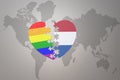 Puzzle heart with the rainbow gay flag and netherlands on a world map background. Concept Royalty Free Stock Photo