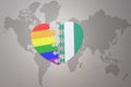 Puzzle heart with the rainbow gay flag and nigeria on a world map background. Concept Royalty Free Stock Photo