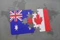 puzzle with the national flag of australia and canada on a world map background. Royalty Free Stock Photo
