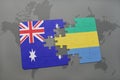 puzzle with the national flag of australia and gabon on a world map background. Royalty Free Stock Photo