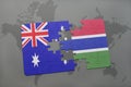 puzzle with the national flag of australia and gambia on a world map background. Royalty Free Stock Photo