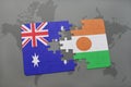 puzzle with the national flag of australia and niger on a world map background. Royalty Free Stock Photo