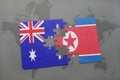 puzzle with the national flag of australia and north korea on a world map background. Royalty Free Stock Photo