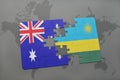 puzzle with the national flag of australia and rwanda on a world map background. Royalty Free Stock Photo