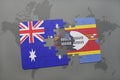 puzzle with the national flag of australia and swaziland on a world map background. Royalty Free Stock Photo