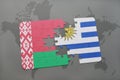 puzzle with the national flag of belarus and uruguay on a world map Royalty Free Stock Photo