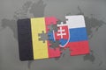 puzzle with the national flag of belgium and slovakia on a world map background.