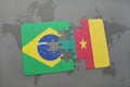 puzzle with the national flag of brazil and cameroon on a world map background. Royalty Free Stock Photo