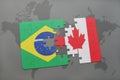 puzzle with the national flag of brazil and canada on a world map background. Royalty Free Stock Photo