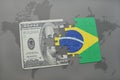 puzzle with the national flag of brazil and dollar banknote on a world map background. Royalty Free Stock Photo