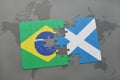 puzzle with the national flag of brazil and scotland on a world map background. Royalty Free Stock Photo