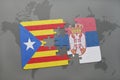 puzzle with the national flag of catalonia and serbia on a world map background. Royalty Free Stock Photo