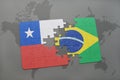 puzzle with the national flag of chile and brazil on a world map background. Royalty Free Stock Photo