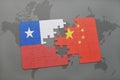 puzzle with the national flag of chile and china on a world map background.