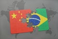 puzzle with the national flag of china and brazil on a world map background. Royalty Free Stock Photo