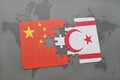 puzzle with the national flag of china and northern cyprus on a world map background. Royalty Free Stock Photo