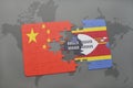 puzzle with the national flag of china and swaziland on a world map background.