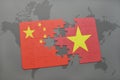 puzzle with the national flag of china and vietnam on a world map background. Royalty Free Stock Photo