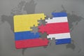 puzzle with the national flag of colombia and costa rica on a world map background. Royalty Free Stock Photo