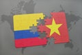 puzzle with the national flag of colombia and vietnam on a world map