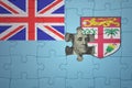 puzzle with the national flag of Fiji and usa dollar banknote. finance concept Royalty Free Stock Photo