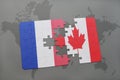 puzzle with the national flag of france and canada on a world map background. Royalty Free Stock Photo