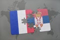 puzzle with the national flag of france and serbia on a world map background. Royalty Free Stock Photo