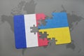 puzzle with the national flag of france and ukraine on a world map background. Royalty Free Stock Photo