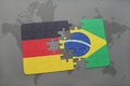 puzzle with the national flag of germany and brazil on a world map background. Royalty Free Stock Photo