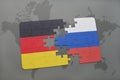 puzzle with the national flag of germany and russia on a world map background.