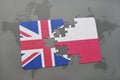 Puzzle with the national flag of great britain and poland on a world map background Royalty Free Stock Photo