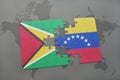 puzzle with the national flag of guyana and venezuela on a world map background.