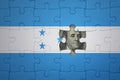 puzzle with the national flag of honduras and usa dollar banknote. finance concept Royalty Free Stock Photo