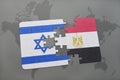 puzzle with the national flag of israel and egypt on a world map background. Royalty Free Stock Photo