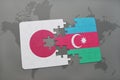 puzzle with the national flag of japan and azerbaijan on a world map background. Royalty Free Stock Photo