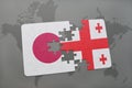 puzzle with the national flag of japan and georgia on a world map background. Royalty Free Stock Photo