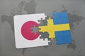 puzzle with the national flag of japan and sweden on a world map background. Royalty Free Stock Photo