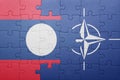 Puzzle with the national flag of laos and nato