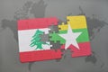 puzzle with the national flag of lebanon and myanmar on a world map background.