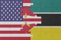 puzzle with the national flag of mozambique and united states of america.macro
